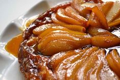 a close up of food on a plate with sauce and carrots in the center