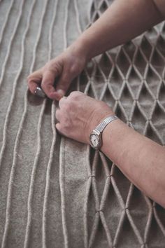 an older woman's hand on top of a bed