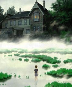 a boy is standing in the water looking at a large house with green grass on it