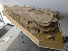 a model of a building with plants growing on it