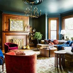 a living room filled with furniture and a fire place in the middle of a room