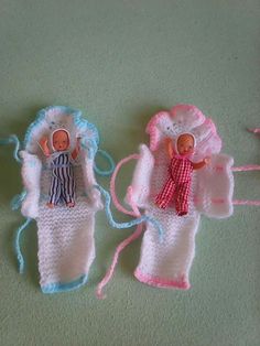 two crocheted dolls are laying on the ground