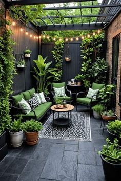 an outdoor patio with green furniture and potted plants