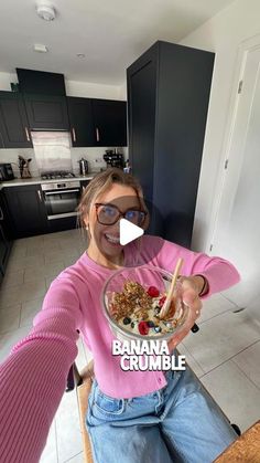 a woman sitting at a table with a bowl of food