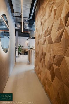 an office hallway with wooden walls and circular mirrors on the wall, as well as round windows