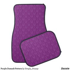 two purple carpeted mats with black trims on the front and back of them