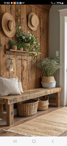 a wooden bench sitting next to a wall with hats on it