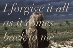 a woman with long blonde hair standing in front of an open field and the words iforgive it all as it comes back to me