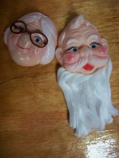 two plastic santa claus heads sitting next to each other