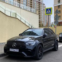 a black mercedes gle is parked on the street