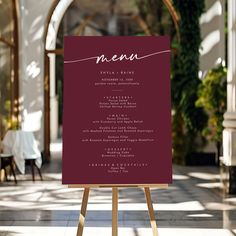 a menu is displayed on an easel in the middle of a room with tables and chairs