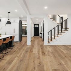 an open floor plan with stairs leading up to the kitchen and dining room area in this home