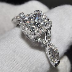 a diamond engagement ring on top of a white cloth with the words sense of style written below it