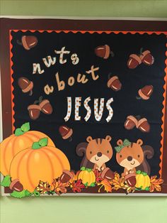 a bulletin board with the words nuts about jesus written on it and two bears holding pumpkins