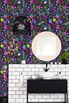 a white sink sitting under a mirror on top of a counter next to a wall