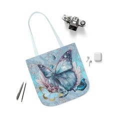 Artwork Tote 'Sky Blue Wings', Butterfly Tote Bag, Light Blue Tote Bag, Light Blue Tote, Butterfly Tote, Beach Tote Bag, Gifts Under 20 Lightweight and durable, this beautiful all-over printed artwork tote bag does it all. The inside has a sleek, black lining and its comfortable straps come in five color choices. Choose any (or all) of the three sizes--for quick errands, shopping trips, and longer travels. The latest printing techniques provide bright and crisp colors and fine details. Created from my abstract artwork, 'Sky Blue Wings'. * 100% Polyester canvas -- fine weave texture fabric and soft foamed lining makes wearing super comfortable * All over artwork print * Available in 3 sizes * Black interior * Boxed corners -- front and back sides are sewn together by creating extra space on Light Blue Pouch Bag As Gift, Light Blue Pouch Bag For Gift, Artistic Blue Bag For Everyday Use, Artistic Blue Bags For Everyday, Artistic Blue Tote Shoulder Bag, Blue Canvas Shoulder Bag Gift, Blue Canvas Shoulder Bag For Gift, Artistic Blue Shoulder Bag For Everyday Use, Blue Pouch-shaped Gift Bag