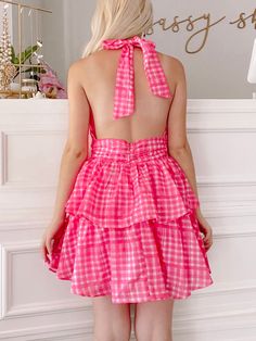 The Razzle Dazzle Dress is a raspberry pink, plaid ruffle open back dress. She features a halter neckline and an adjustable tie around the neck. Lined. Summer Pink Backless Halter Dress, Pink Backless Halter Dress For Summer, Pink Tie-back Backless Halter Dress, Pink Mini Dress With Tie Back And Ruffled Straps, Flirty Ruffled Dresses For Picnic, Summer Halter Dress With Ruffles, Party Halter Dress With Smocked Back And Backless Design, Pink Summer Halter Backless Dress, Pink Fitted Halter Dress With Tie Back