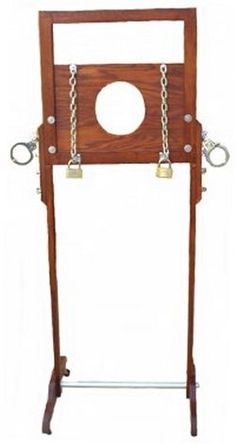 a wooden frame with two metal chains hanging from it's sides and an oval hole in the middle