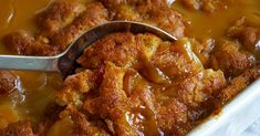 a close up of a spoon in a casserole dish