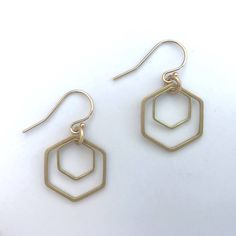 "These gold hexagons earrings are made of two brass hex dangling on 14K gold filled earwire. Layering two sizes of hexagon adds fullness to the open design. They have nice dangle movement from the connections. The hexagon is one of the most common shapes in nature. From honeycomb to snowflakes and patterns found on fruit skins. It's no surprise there is a resurgence of this geometric shape in design. These gold hexagon earrings have a more retro feel than the silver ones. ∙ ∙ ∙ ∙ ∙ ∙ ∙ ∙ ∙ ∙ ∙ ∙ Nickel Free Gold Hexagon Jewelry, Minimalist Gold Octagon Earrings, Gold Hexagon Earrings For Everyday, Shapes In Nature, Honeycomb Jewelry, Hexagon Earrings, Self Gift, Retro Earrings, Retro Earring