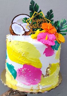 a colorful cake with coconuts and flowers on it