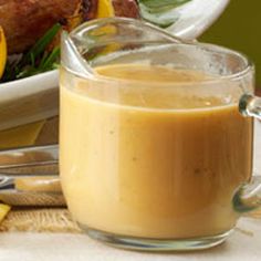 a glass pitcher filled with liquid next to a plate of food