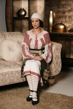 a woman sitting on top of a couch in a living room