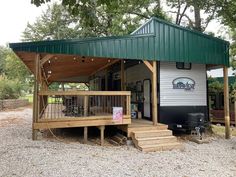 a mobile home with a covered porch and stairs leading up to the front door area