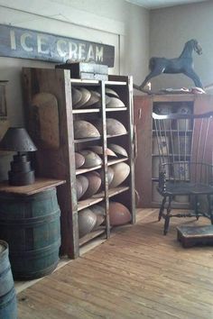 an old room with wooden floors and lots of items on the shelves, including a horse statue