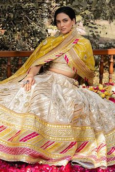 Ivory lehenga with gota patti embroidery and multicolor striped border. Comes with blouse and dupatta.
Components:3
Pattern:Embroidery
Type of Work:Gota Patti
Sleeve Length:Half
Fabric:Handwoven Chanderi Banarasi, Chanderi Silk, Tissue Chanderi and Shantoon 
Color:White
Other Details:
Dupatta with striped border
Panelled lehenga
Occasion:Wedding - Aza Fashions Chanderi Silk Lehenga, Purple Lehenga, Unique Bridesmaid Dresses, Raw Silk Lehenga, Tarun Tahiliani, Silk Lehenga, Designer Gowns, Kids Sleepwear, Raw Silk