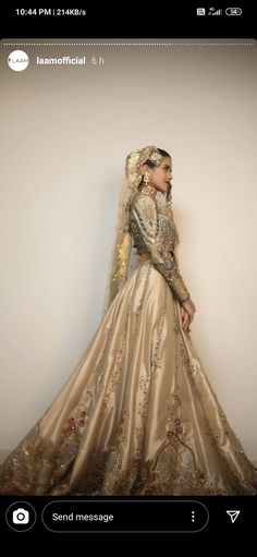 a woman in a wedding dress standing against a wall