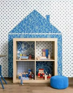 a doll house with blue walls and furniture