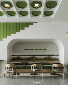 the interior of a restaurant with green and white decor on the walls, tables and chairs