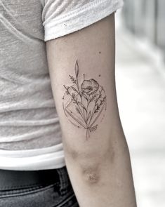 a woman's arm with a flower tattoo on the left side of her arm