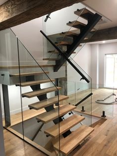 a wooden and glass staircase in a house