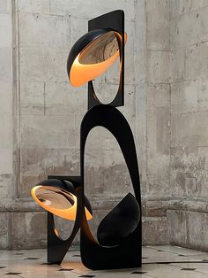 an abstract sculpture with three lights on it