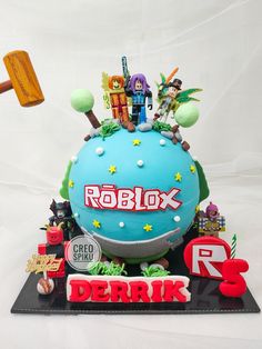 a cake that is decorated with toys and letters