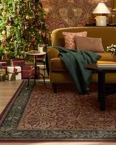 a living room filled with furniture and christmas tree in the background, surrounded by holiday decorations