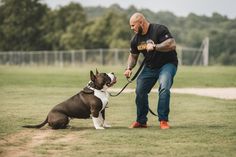 a man with a dog on a leash