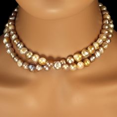 Gorgeous and elegant 32-inch freshwater pearl necklace in shades of gold, mauve, and gray. This unique 8-10mm pearl necklace is luscious. The glowing pearls are a delight to wear. At 32 inches it can possibly be a double strand tightly wrapped. A barrel clasp in gold over sterling is the clasp that secures this unique necklace. Pearls are Mother Nature’s gift from the Sea. They are organic gemstones formed inside either freshwater or saltwater mollusks. The type of mollusk producing the pearl influences the body color. Most mollusks have been assisted by the insertion of a bit natural material inserted into its shell around which it can lay down layers of nacre. These cultured pearls come in a variety of natural colors including gold, white, gray. Pearls can be bleached and dyed to create Fresh Water Pearl Necklace, Genuine Pearl Necklace, Water Pearl Necklace, Gold Pearl Necklace, Freshwater Pearl Necklace, Shades Of Gold, Fresh Water Pearl, Modern Necklaces, Cool Necklaces