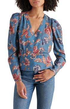 A boho-inspired floral print covers this drapey georgette top framed by puffed sleeves and finished with a silhouette-defining peplum. 22 1/2" length Hidden side-zip closure V-neck Long sleeves with button-and-loop cuffs 100% polyester Hand wash, dry flat Imported Blue Fitted Blouse With Balloon Sleeves, Brunch Floral Print Puff Sleeve Top, Brunch Floral Print Puff Sleeve Long Top, Floral Print Long Sleeve Puff Sleeve Top For Brunch, Fitted Blue Blouse With Gathered Sleeves, Fitted Long Sleeve Puff Top With Floral Print, Chic Tops With Floral Print And Bishop Sleeves, Blue Fitted Puff Sleeve Top For Fall, Chic Long Sleeve Puff Top With Floral Print