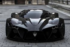 a black and white car parked on top of a brick road