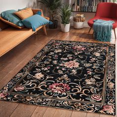 a living room area with a rug, chair and bookshelf on the floor