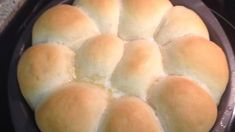 a pan filled with bread sitting on top of a stove