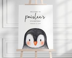 a penguin birthday card on an easel