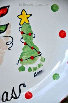 a close up of a plate with a christmas tree painted on the front and bottom