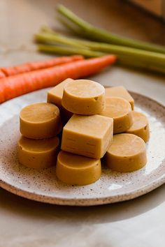 a white plate topped with cut up carrots and tofu