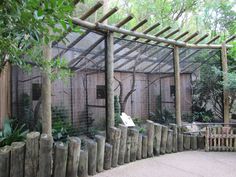 a fenced in area with trees and plants