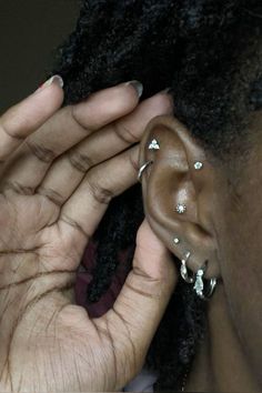 a close up of a person with ear piercings