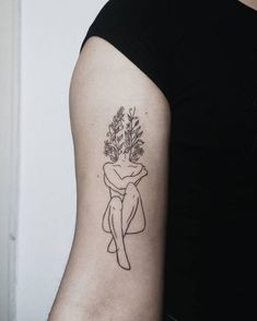 a woman with a flower tattoo on her arm